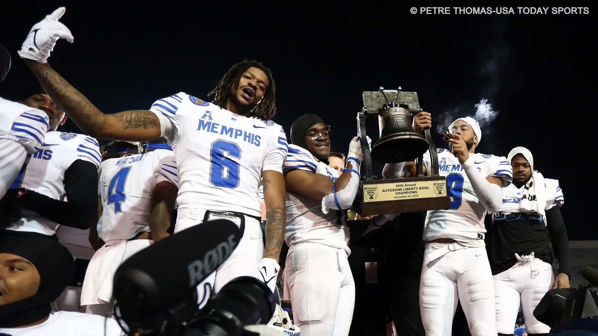 Memphis Tigers defensive linemen Derick Hunter Jr. (6), linebacker Chandler Martin (11) and linebacker Geoffrey Cantin-Arku (9) celebrate after defeating the Iowa State Cyclones in the Liberty Bowl at Simmons Bank Liberty Stadium.