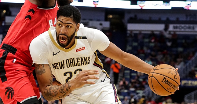 New Orleans Pelicans forward Anthony Davis (23) drives past Toronto Raptors center Greg Monroe (15) during the first half at the Smoothie King Center.