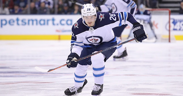 Winnipeg Jets center Jack Roslovic (28) skates after the puck in the first period against the Toronto Maple Leafs at Scotiabank Arena.