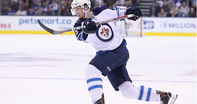 Winnipeg Jets defenseman Jacob Trouba (8) shoots against the Toronto Maple Leafs at Scotiabank Arena.