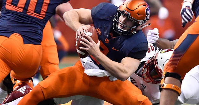 Syracuse Orange quarterback Eric Dungey (2) is tackled by Louisville Cardinals defensive end Tabarius Peterson (98) during the first quarter at the Carrier Dome.
