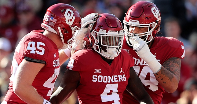 Oklahoma Sooners running back Trey Sermon (4) celebrates with teammates after running for a touchdown during the first quarter against the Oklahoma State Cowboys at Gaylord Family - Oklahoma Memorial Stadium.
