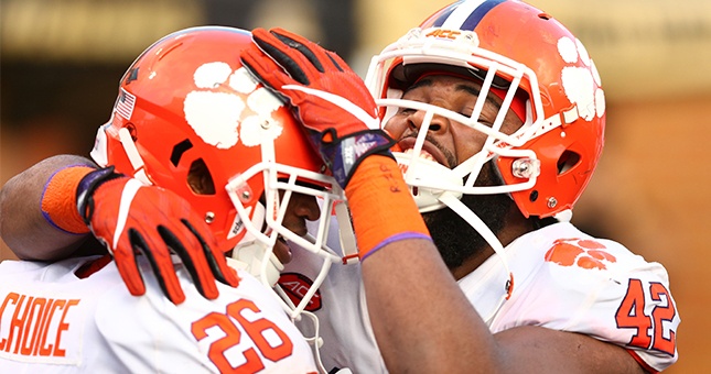 Clemson Tigers defensive lineman Christian Wilkins (42) celebrates with running back Adam Choice (26) after a touchdown in the third quarter against the Wake Forest Demon Deacons at BB&T Field.