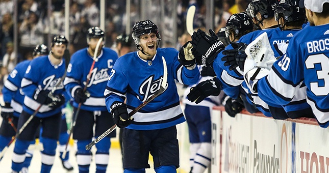 Winnipeg Jets forward Nikolaj Ehlers (27) is congratulated by his teammates on his goal against the Toronto Maple Leafs during the third period at Bell MTS Place.