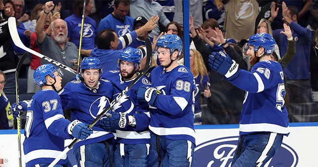 Tampa Bay Lightning center Tyler Johnson (second from left) is congratulated by center Yanni Gourde (37), right wing Nikita Kucherov (86), defenseman Mikhail Sergachev (98) and defenseman Braydon Coburn (55) after scoring a goal against the New York Islanders during the third period at Amalie Arena.