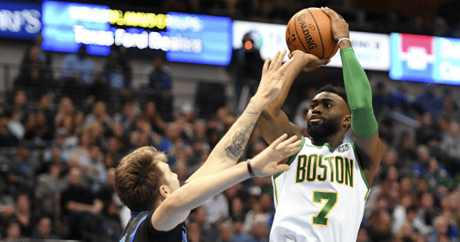 Boston Celtics guard Jaylen Brown shoots over Dallas Mavericks forward Luka Doncic.
