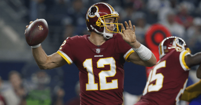 Washington Redskins quarterback Colt McCoy (12) throws a pass in the first quarter against the Dallas Cowboys at AT&T Stadium.