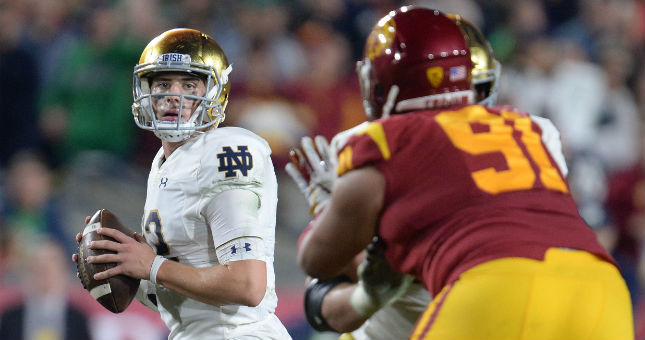 Notre Dame Fighting Irish quarterback Ian Book (12) throws as Southern California Trojans defensive lineman Brandon Pili (91) moves in during the first half at the Los Angeles Memorial Coliseum.