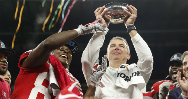 Ohio State coach Urban Meyer and wide receiver Terry McLaurin (83) hold up the trophy after defeating Northwestern in the Big Ten conference championship game.