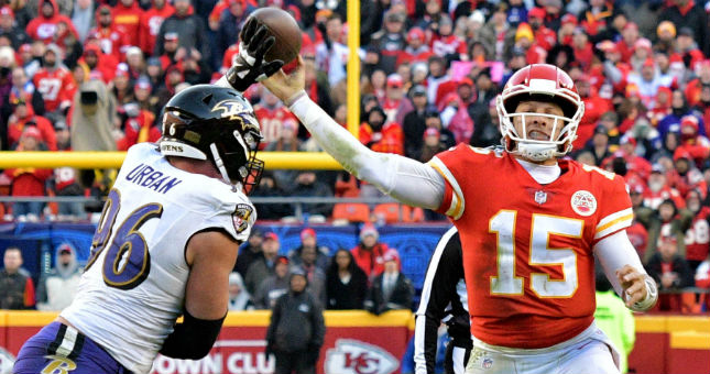 Kansas City Chiefs quarterback Patrick Mahomes (15) throws a pass as Baltimore Ravens defensive end Brent Urban (96) defends during the second half at Arrowhead Stadium.