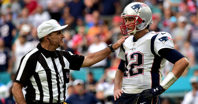 New England Patriots quarterback Tom Brady (right) talks with referee Pete Morelli (left) during the second half against the Miami Dolphins.