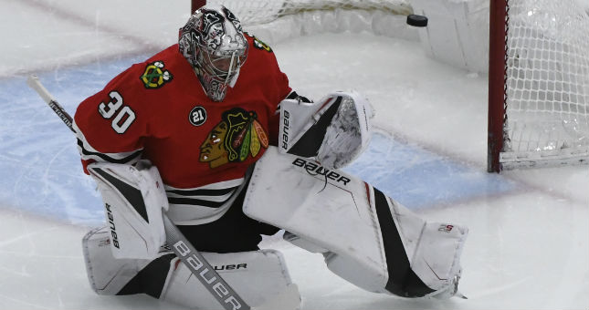 Chicago Blackhawks goaltender Cam Ward (30) tries to block a shot from the Nashville Predators during the first period at the United Center.