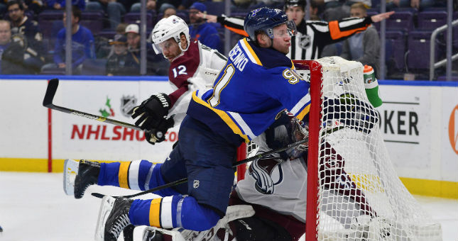 St. Louis Blues right wing Vladimir Tarasenko (91) collides with Colorado Avalanche goaltender Philipp Grubauer (31) .
