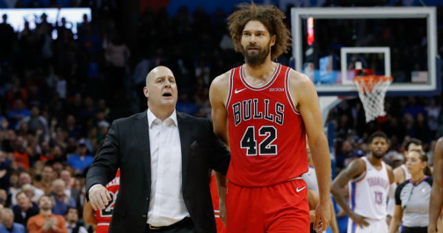 Chicago Bulls head coach Jim Boylen, left, walks with center Robin Lopez, right, off the court.
