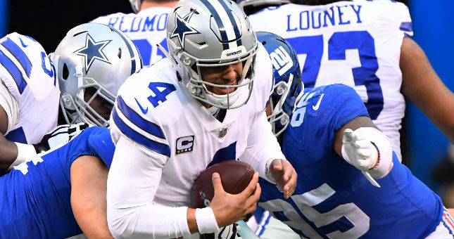 Giants linebacker Olivier Vernon (54) and defensive tackle B.J. Hill (95) tackle Cowboys quarterback Dak Prescott (4).