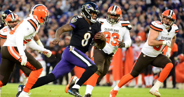 Ravens quarterback Lamar Jackson (8) scores a touchdown in the second quarter against the Browns.