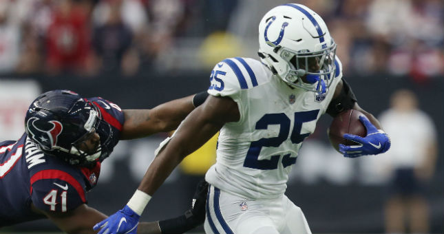 Colts running back Marlon Mack (25) runs against Houston inside linebacker Zach Cunningham (41) in the first half in a AFC Wild Card playoff football game at NRG Stadium.