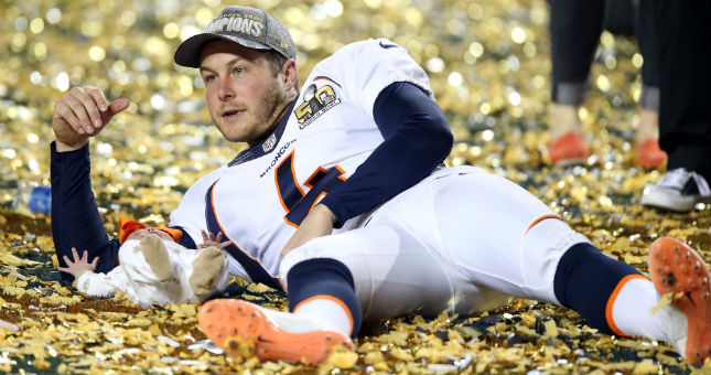 Broncos punter Britton Colquitt (4) lays in the confetti with his baby after beating the Panthers in Super Bowl 50.