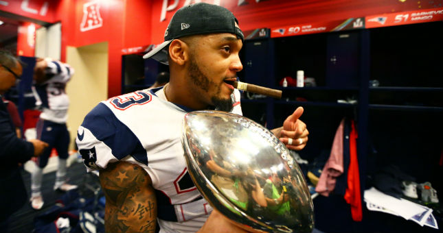 Patriots safety Patrick Chung (23) celebrates in the locker room with the Vince Lombardi trophy after defeating the Atlanta Falcons during Super Bowl LI.
