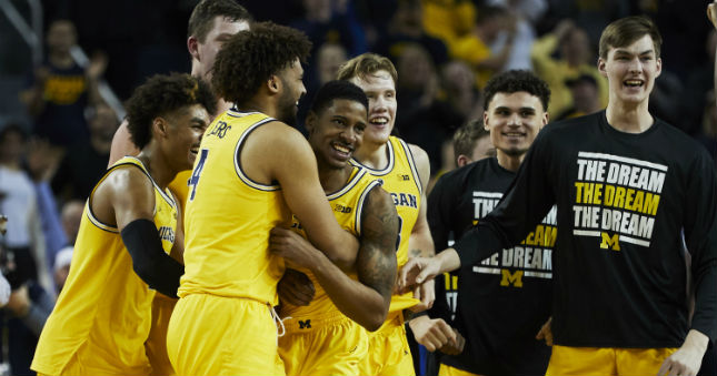 Michigan Wolverines guard Charles Matthews (1) is congratulated by teammates after he hits a game winning basket at the buzzer against the Minnesota Golden Gophers at Crisler Center.