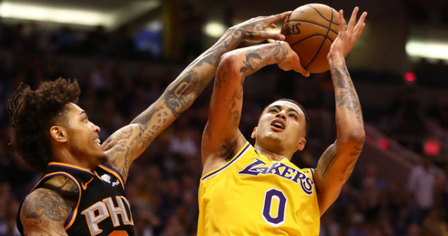 Lakers forward Kyle Kuzma (0) has his shot blocked by Suns forward Kelly Oubre Jr.
