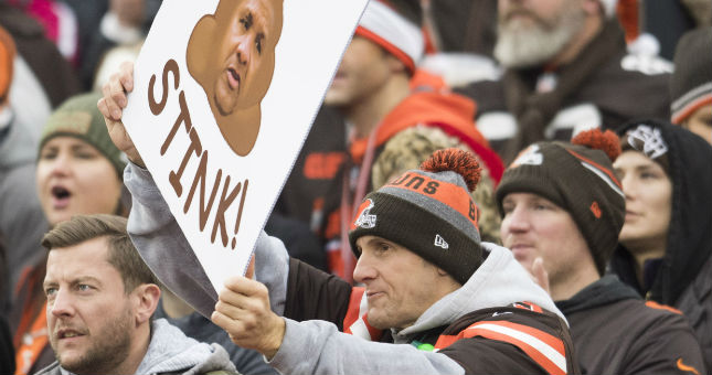 A Cleveland Browns fan holds a sign referencing former coach Hue Jackson during a game against the Bengals.