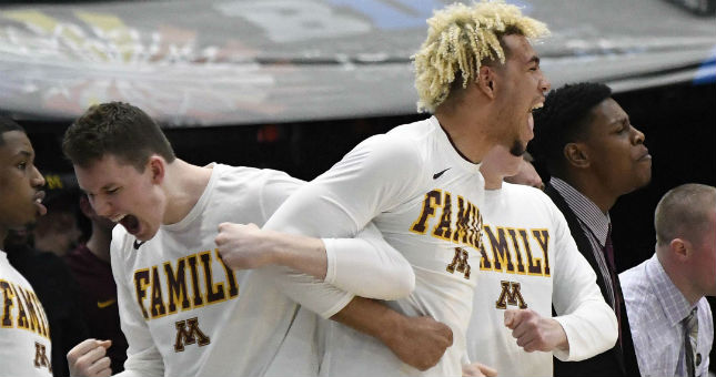 The Minnesota Golden Gophers bench celebrate a basket against Purdue.
