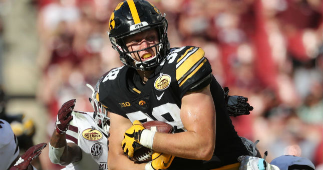 T.J. Hockenson runs with the ball as Mississippi State tries to tackle him.