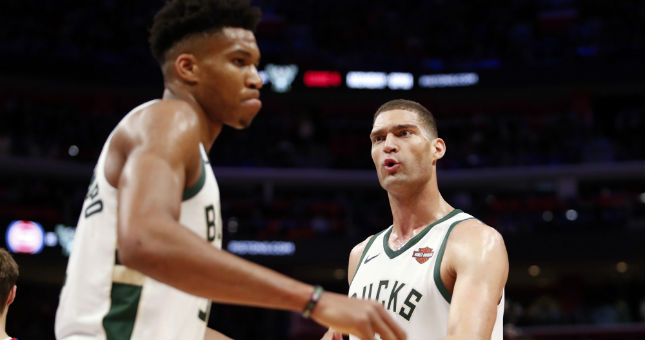 Bucks center Brook Lopez (11) gives five to forward Giannis Antetokounmpo (34) during the second quarter against the Pistons.
