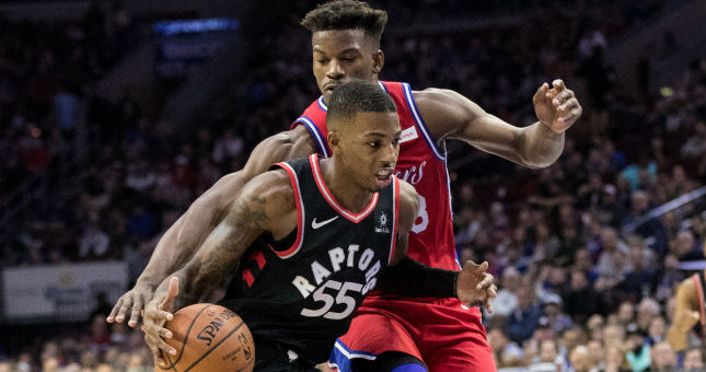 76ers guard Jimmy Butler attempts to knock away the ball from Raptors guard Delon Wright.