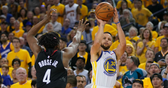 Warriors guard Stephen Curry shoots the basketball against Rockets forward Danuel House Jr.